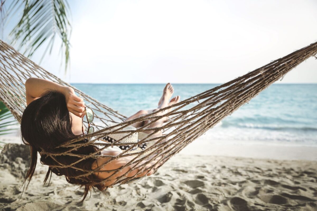 Woman relaxing in hammock on Anna Maria Island beach