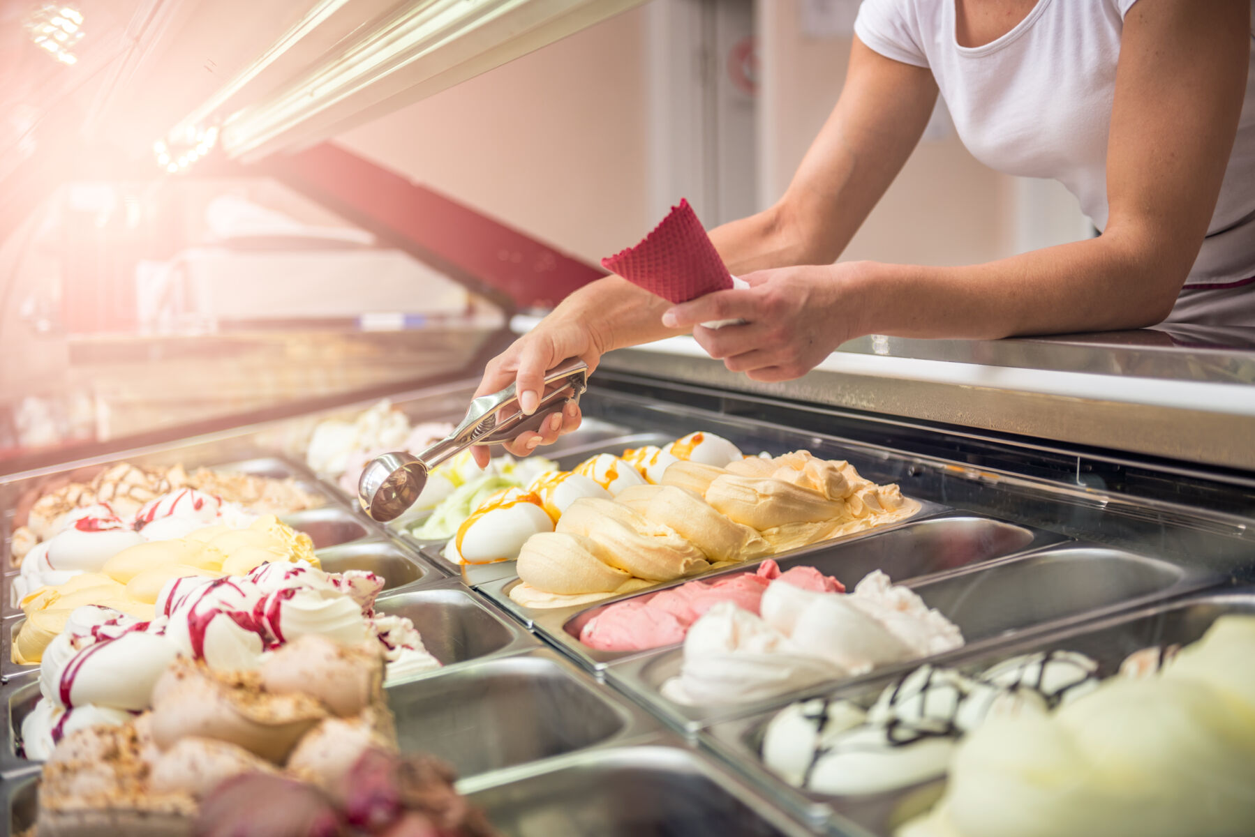 Employee scooping ice cream