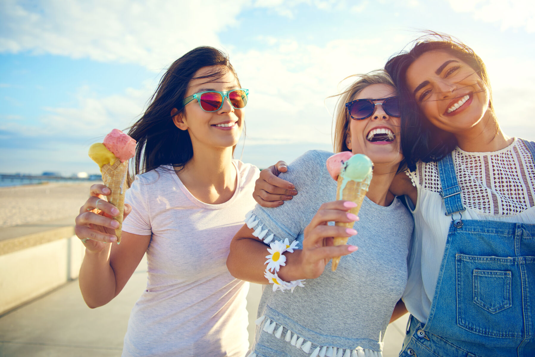Women eating ice cream on the beach.